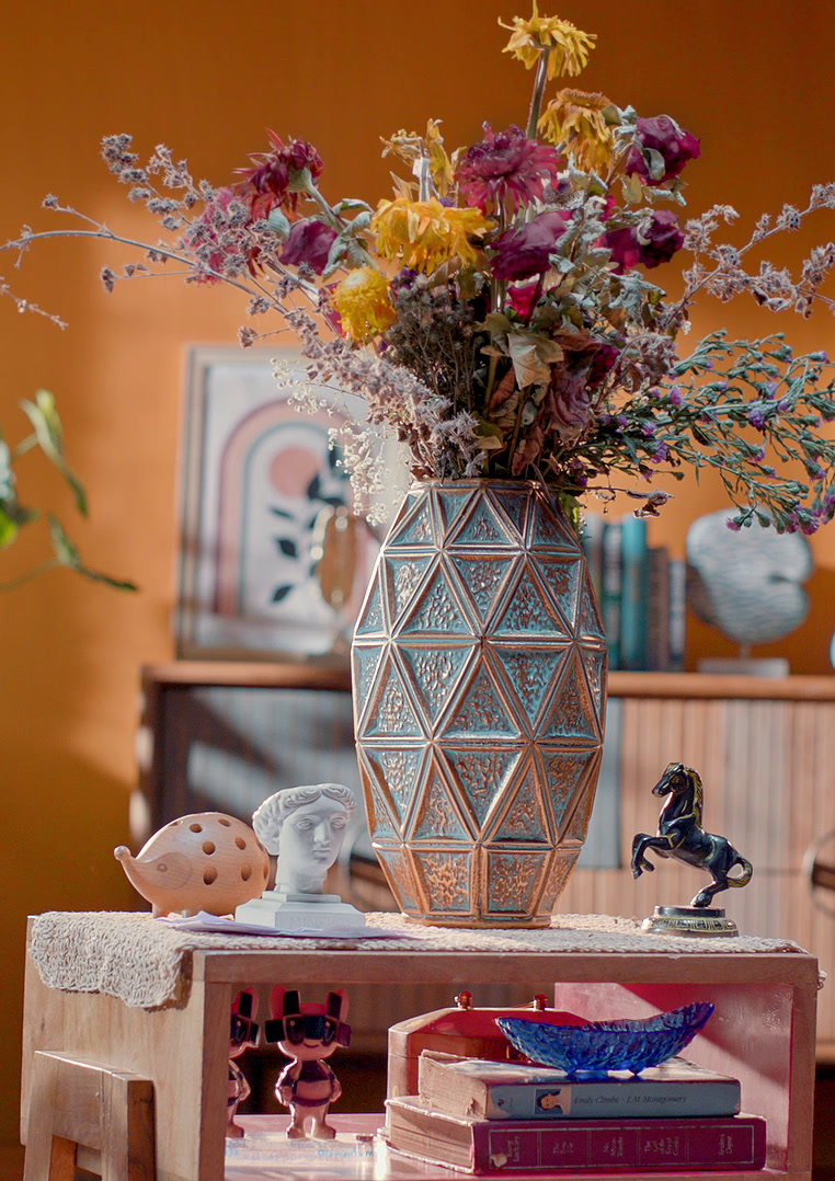 Hand arranging flowers in a vase, JK Cement Wallmaxx · Phooldaan