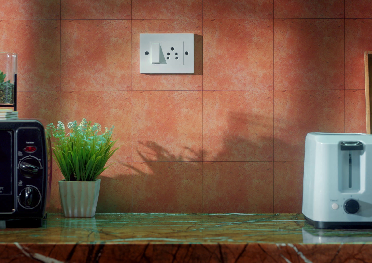 A hand reaching for a wall switch, JK Cement Wallmaxx · Lovely