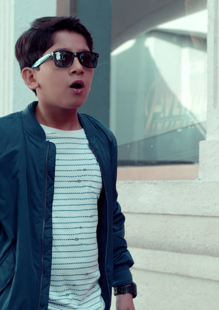 Boy in sunglasses holding a lollipop, Hamleys