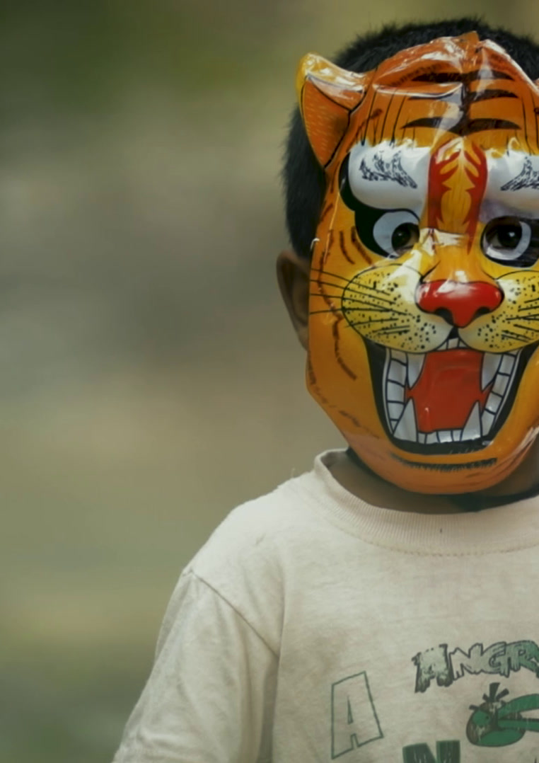 Child wearing a tiger mask, Mystic Mother